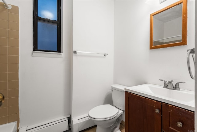 bathroom with a tile shower, vanity, toilet, and a baseboard heating unit