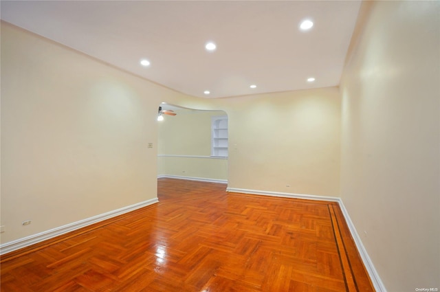 unfurnished room featuring parquet floors