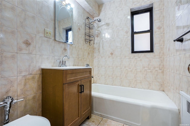 bathroom featuring tile patterned flooring, vanity, tile walls, and tiled shower / bath combo