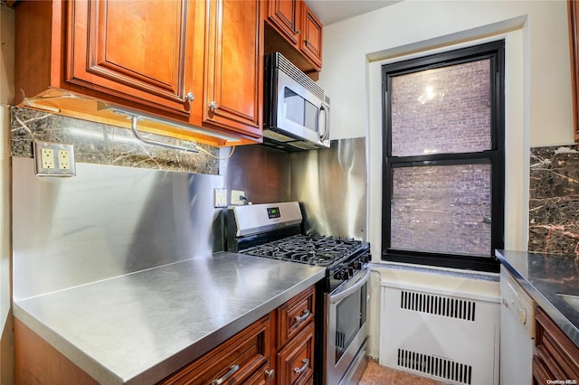 kitchen with decorative backsplash, stainless steel appliances, radiator, and stainless steel counters