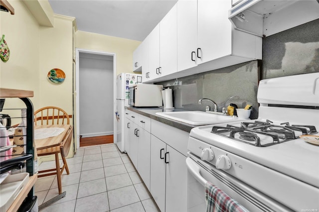 kitchen with white appliances, backsplash, sink, light tile patterned floors, and extractor fan