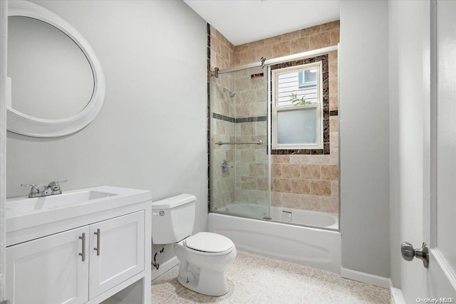 full bathroom with tile patterned floors, vanity, bath / shower combo with glass door, and toilet