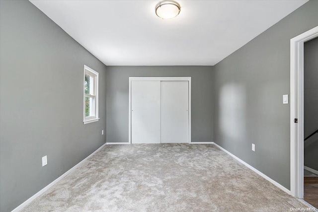 unfurnished bedroom featuring carpet floors and a closet