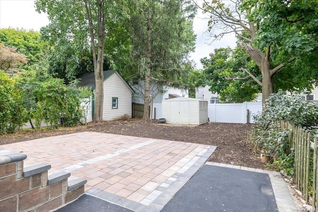 view of patio / terrace featuring a storage unit