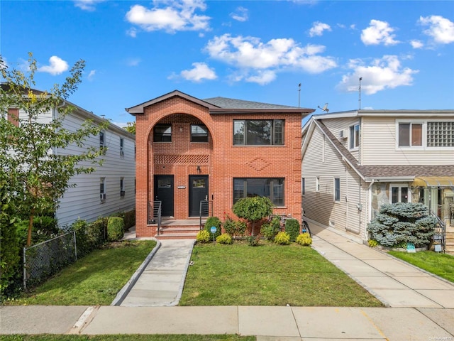 view of front of house featuring a front yard, fence, and brick siding