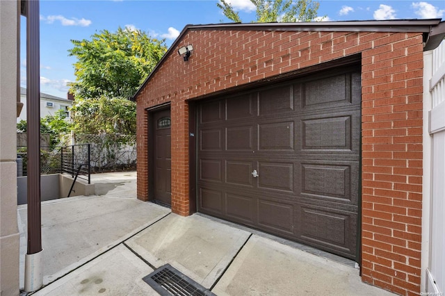 detached garage featuring fence