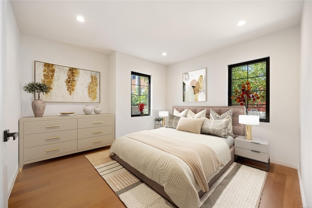 bedroom featuring light wood-type flooring and recessed lighting