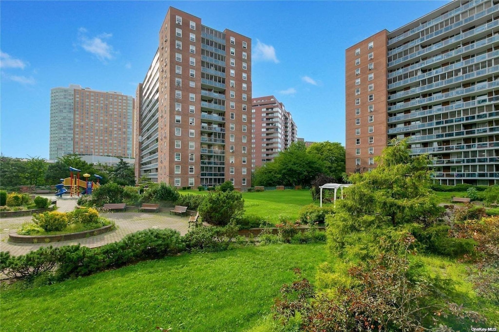 98-20 62nd Dr Unit 11A, Rego Park, NY 11374 - view of property's community with a yard