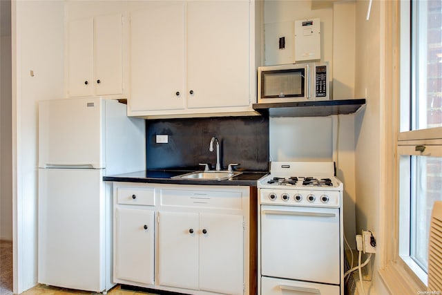 kitchen with white cabinets, decorative backsplash, white appliances, and sink