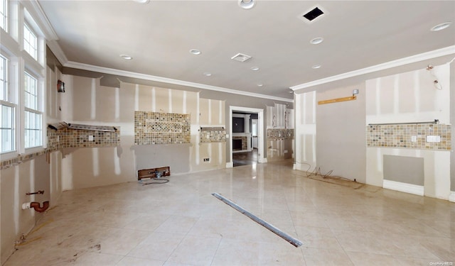 kitchen with light tile patterned floors, backsplash, plenty of natural light, and ornamental molding