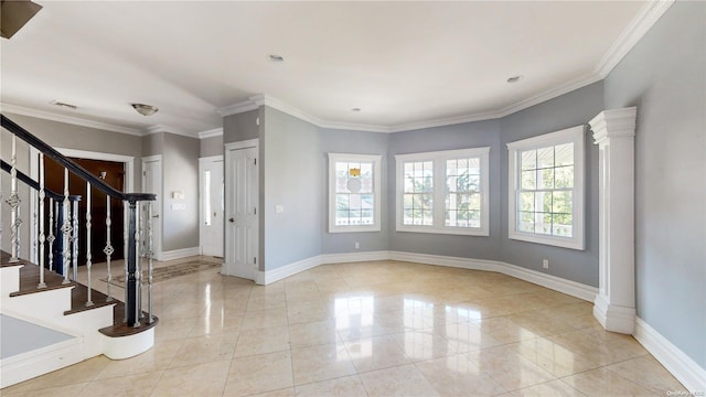 foyer with light tile patterned floors and ornamental molding