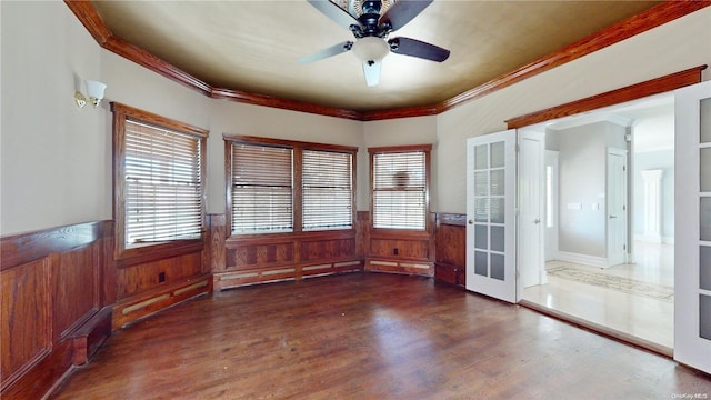 empty room with french doors, dark hardwood / wood-style flooring, ceiling fan, and ornamental molding