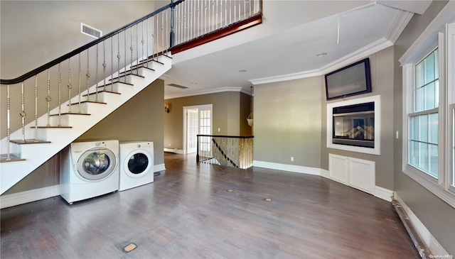 laundry room featuring washer and clothes dryer, hardwood / wood-style floors, and a wealth of natural light