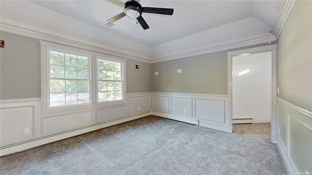 carpeted spare room featuring lofted ceiling, baseboard heating, crown molding, and ceiling fan