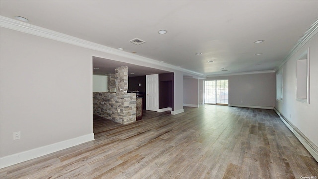 unfurnished living room with wood-type flooring and ornamental molding