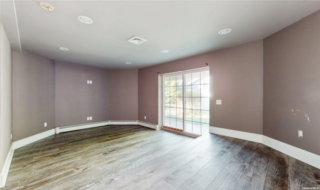 empty room with hardwood / wood-style floors