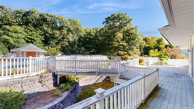 wooden deck with a covered pool