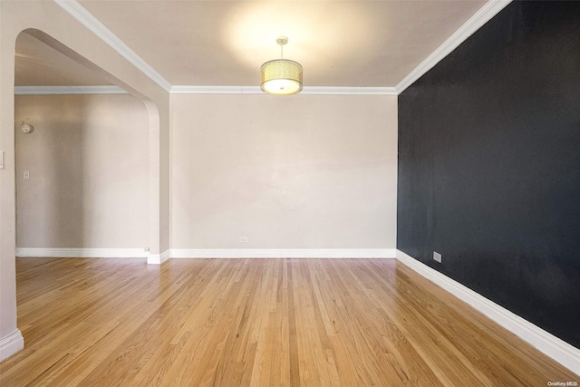 unfurnished room with ornamental molding and light hardwood / wood-style flooring