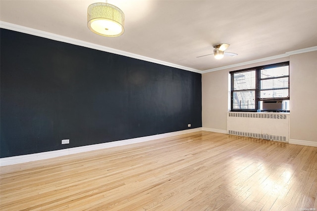 unfurnished room with radiator, ceiling fan, crown molding, cooling unit, and light hardwood / wood-style floors