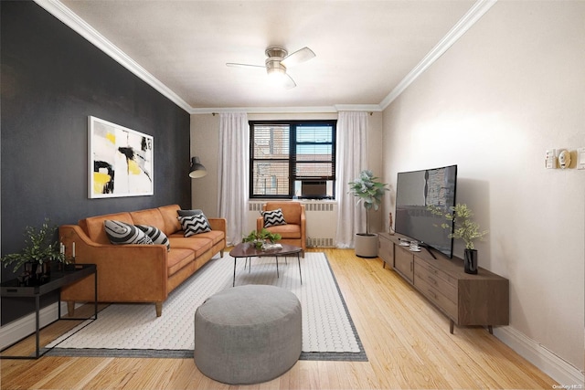 living room featuring ceiling fan, light hardwood / wood-style floors, radiator heating unit, and ornamental molding