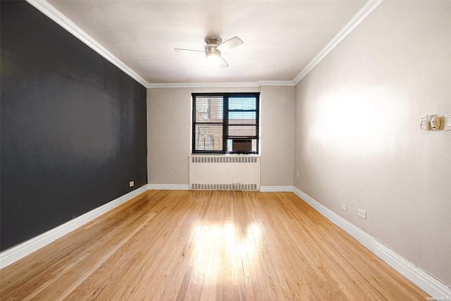 empty room featuring ceiling fan, light hardwood / wood-style floors, crown molding, and radiator