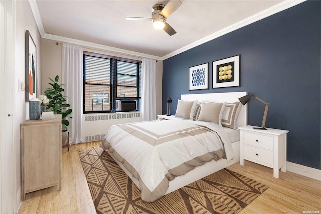 bedroom with ceiling fan, light wood-type flooring, and crown molding