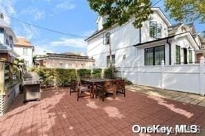 view of patio featuring fence and outdoor dining space