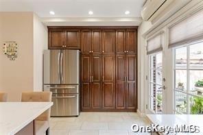 kitchen featuring light countertops, freestanding refrigerator, and recessed lighting