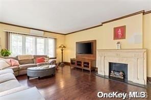 7523 Narrows Ave, Brooklyn, NY 11209 - living room with crown molding, wood finished floors, and a fireplace