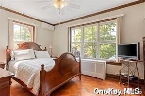 bedroom featuring multiple windows and crown molding