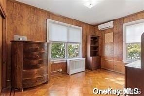 unfurnished office with wooden walls and an AC wall unit