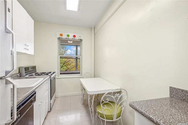 kitchen featuring light tile patterned floors, white cabinetry, and appliances with stainless steel finishes