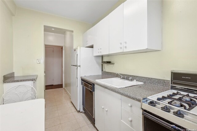 kitchen with gas stove, sink, dishwasher, white cabinetry, and light tile patterned flooring