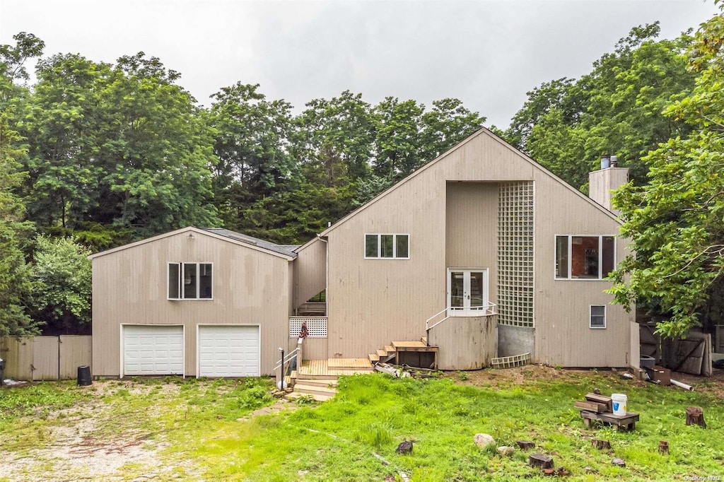 back of house with french doors and a garage