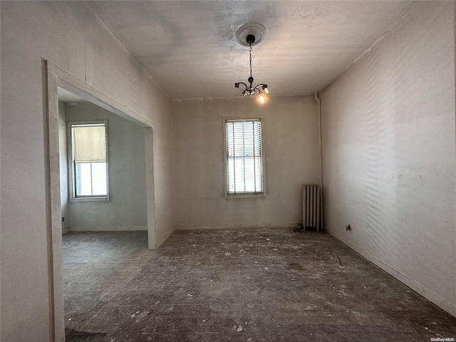 empty room featuring a chandelier