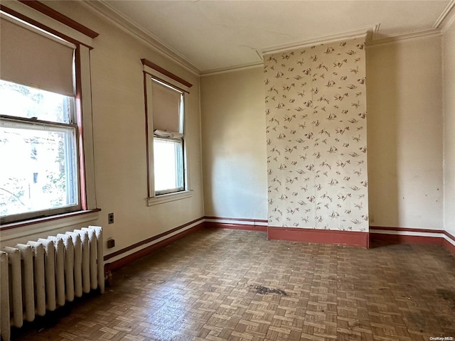 empty room featuring dark parquet flooring, radiator, and ornamental molding