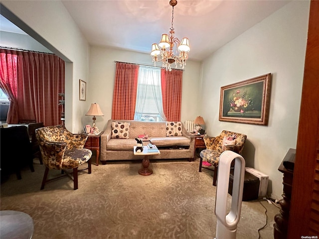 sitting room with carpet floors and an inviting chandelier