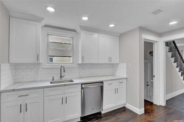 kitchen with stainless steel dishwasher, white cabinetry, sink, and dark wood-type flooring