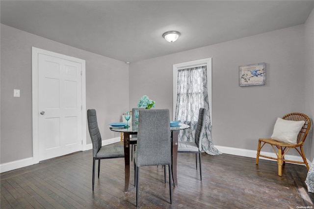 dining space with dark hardwood / wood-style floors