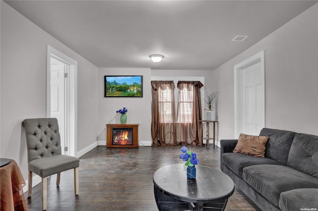 living room with dark hardwood / wood-style flooring