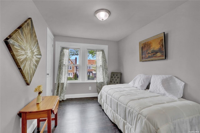 bedroom with dark wood-type flooring