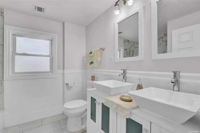 bathroom with tile patterned floors, a shower, vanity, and toilet