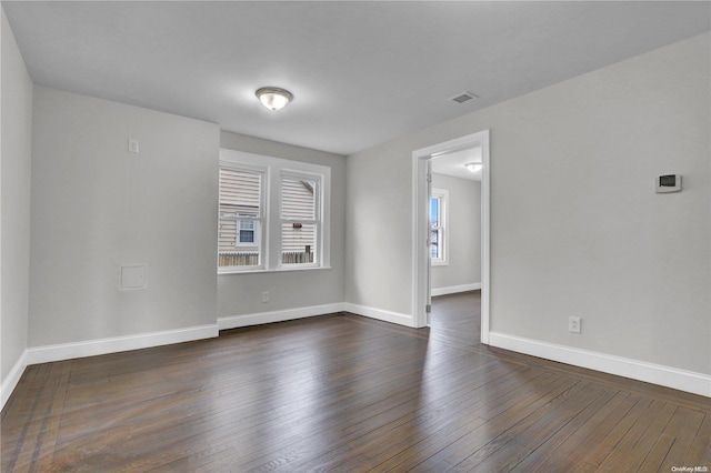 unfurnished room featuring dark hardwood / wood-style flooring