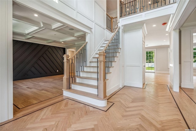 stairway featuring hardwood / wood-style flooring, crown molding, beamed ceiling, and coffered ceiling