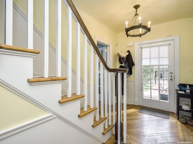 entrance foyer with hardwood / wood-style flooring and an inviting chandelier