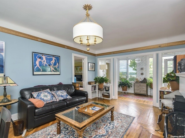 living room with an inviting chandelier, parquet floors, and crown molding