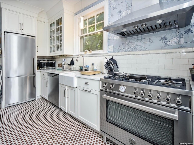 kitchen with white cabinetry, sink, wall chimney exhaust hood, and appliances with stainless steel finishes