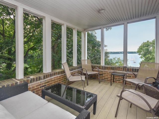 sunroom / solarium featuring a water view