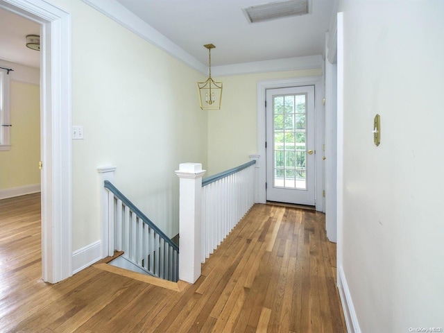 doorway featuring hardwood / wood-style floors and an inviting chandelier