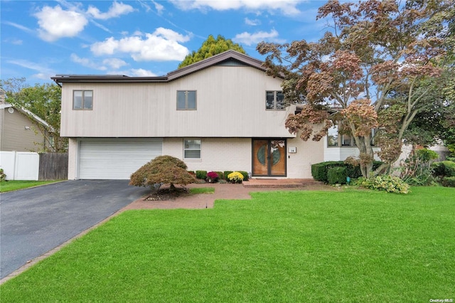 view of front facade with a front yard and a garage